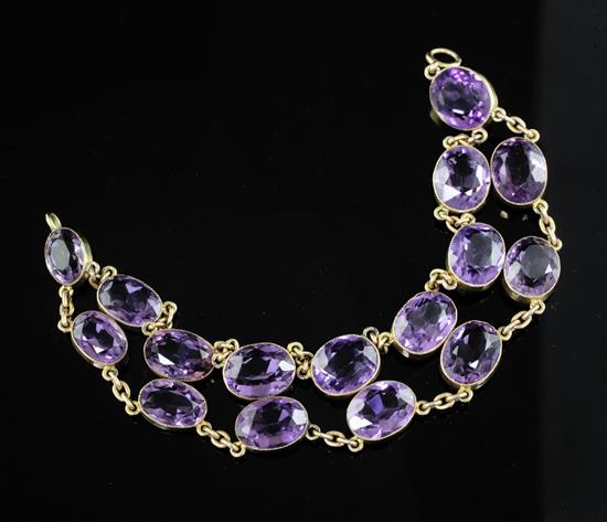 An attractive early to mid 20th century gold and twin row amethyst chain link bracelet, 19cm.